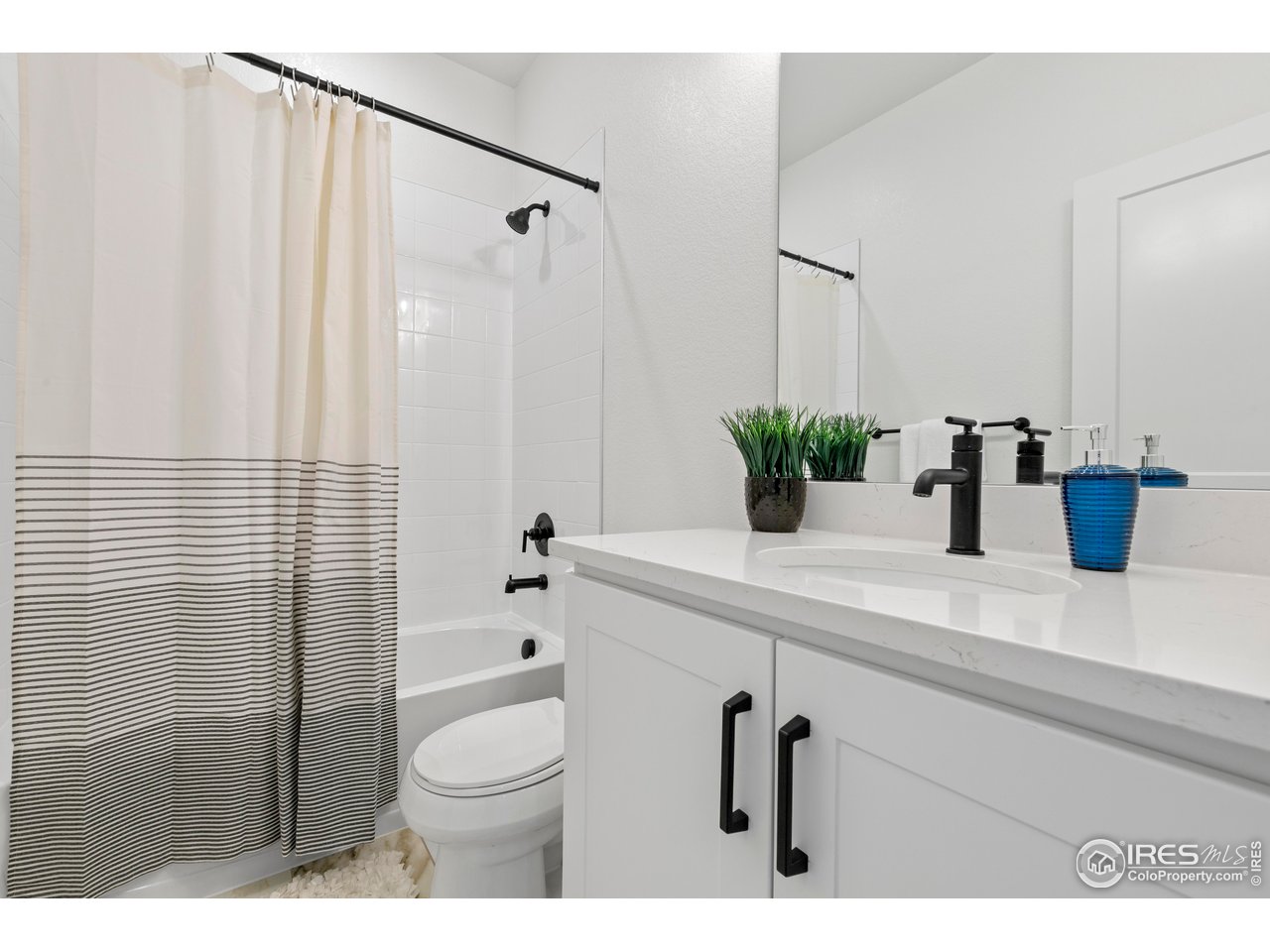797 Muturu Road Johnstown, CO 80534 - Photo 18 of 26 a bathroom with a sink a toilet and shower