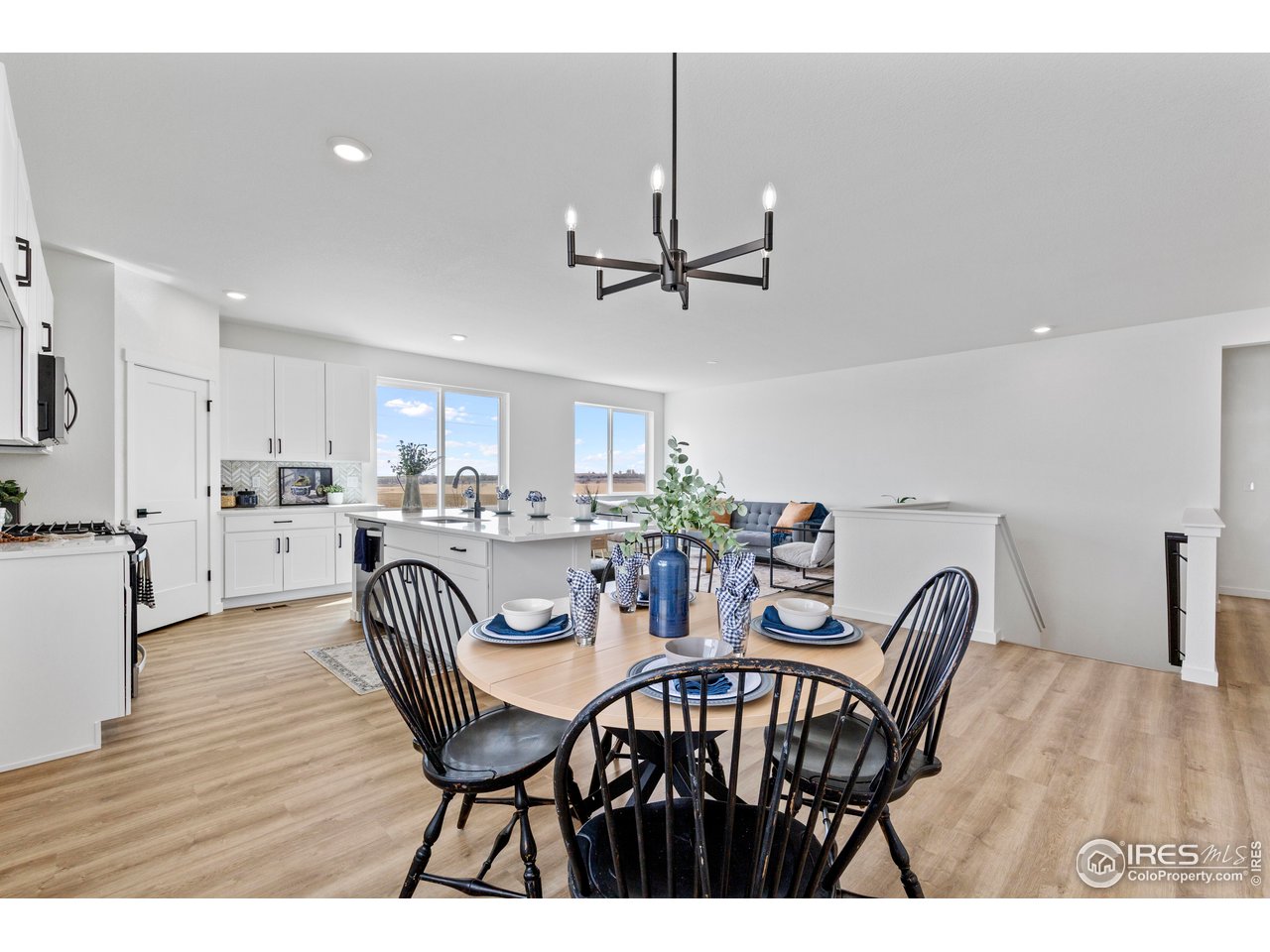 797 Muturu Road Johnstown, CO 80534 - Photo 6 of 26 a view of a dining room with furniture and wooden floor