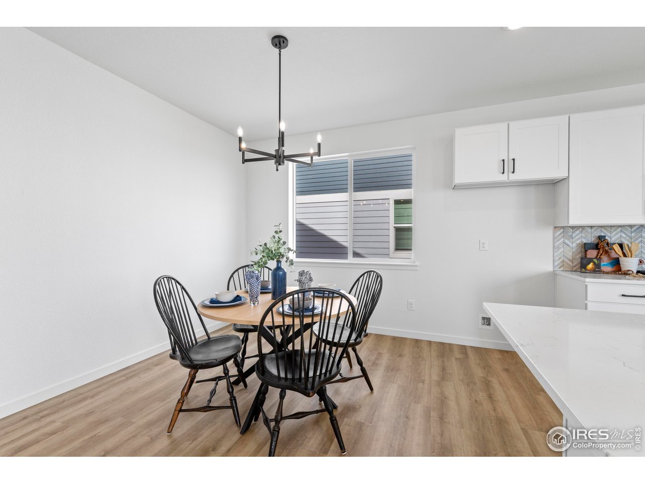 797 Muturu Road Johnstown, CO 80534 - Photo 7 of 26 a view of a dining room with furniture and wooden floor