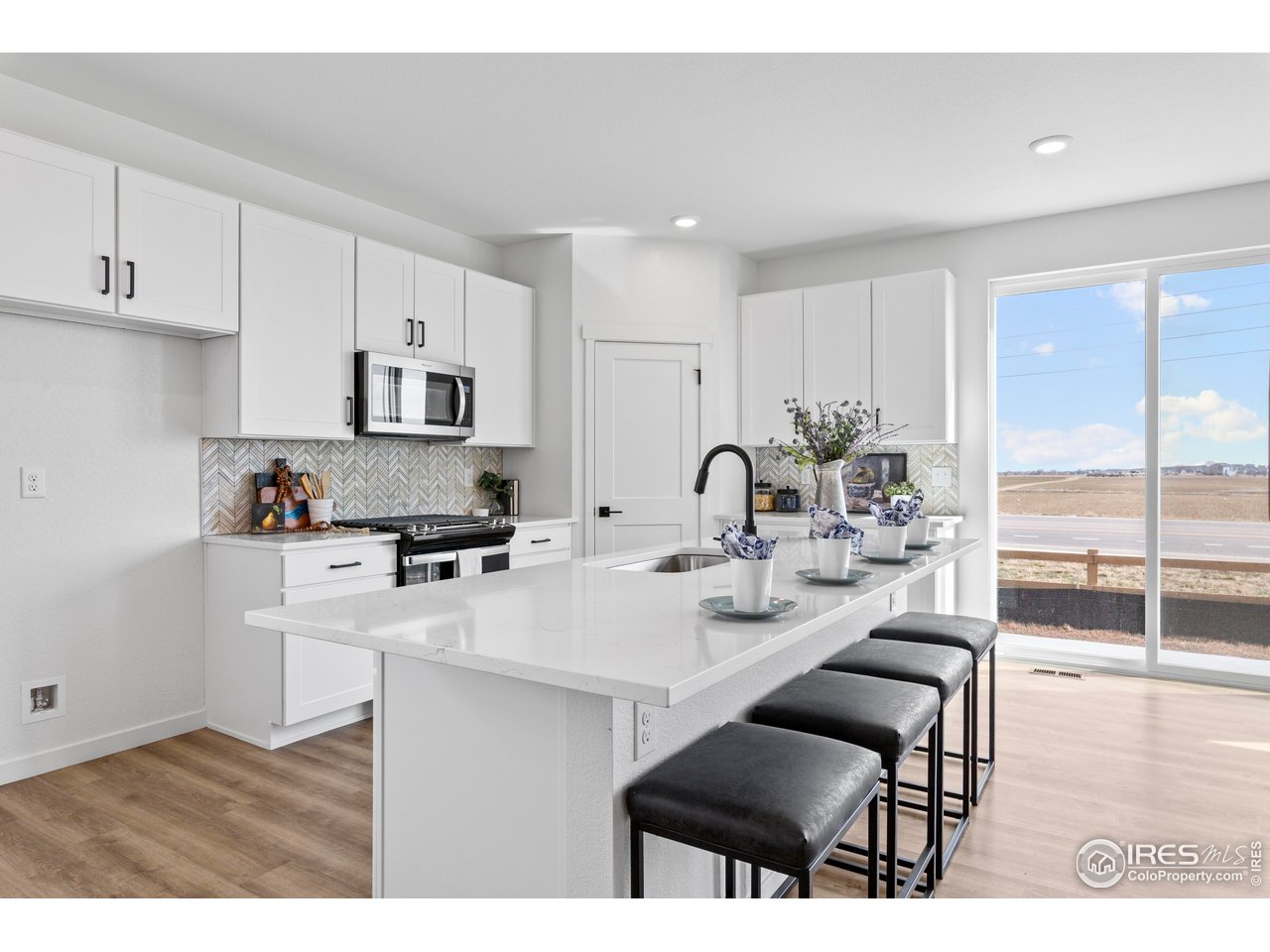 797 Muturu Road Johnstown, CO 80534 - Photo 9 of 26 a kitchen with a sink cabinets and wooden floor