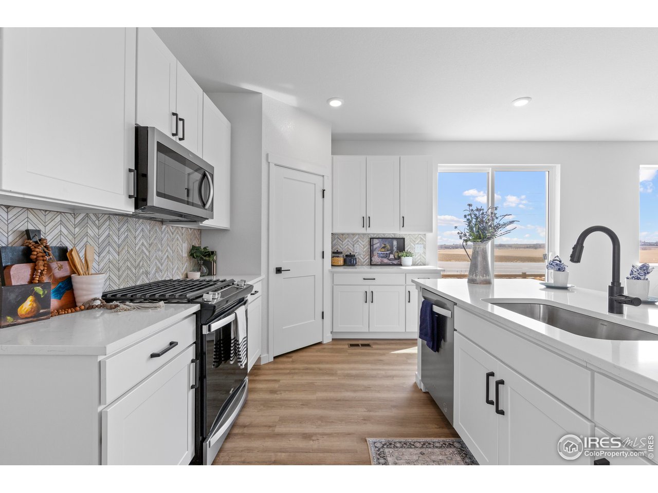 797 Muturu Road Johnstown, CO 80534 - Photo 10 of 26 a kitchen with stainless steel appliances granite countertop a sink stove and refrigerator