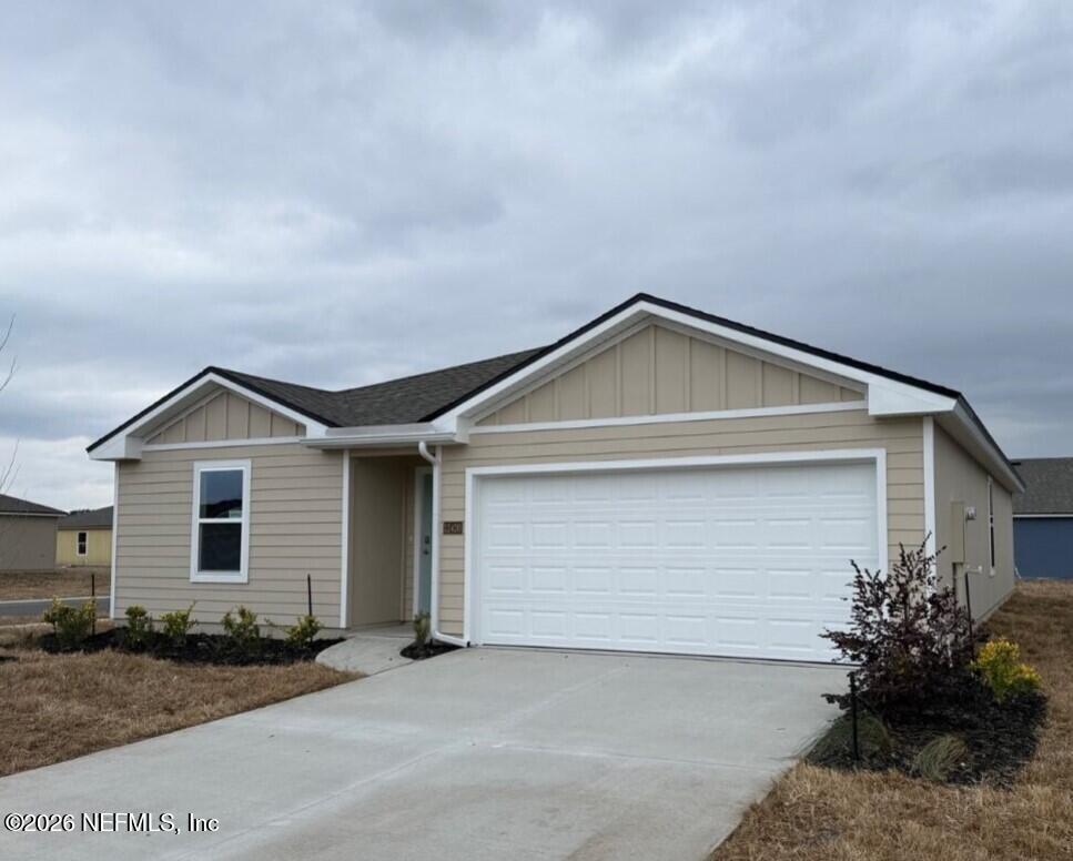 12420 Russian Olive Road Jacksonville, FL 32218 - Photo 3 of 36 a front view of a house with a yard and garage
