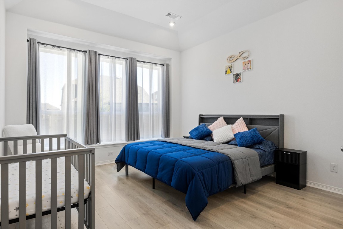 1132 Spring Gulch Lane Georgetown, TX 78628 - Photo 15 of 36 a bedroom with a bed and a window