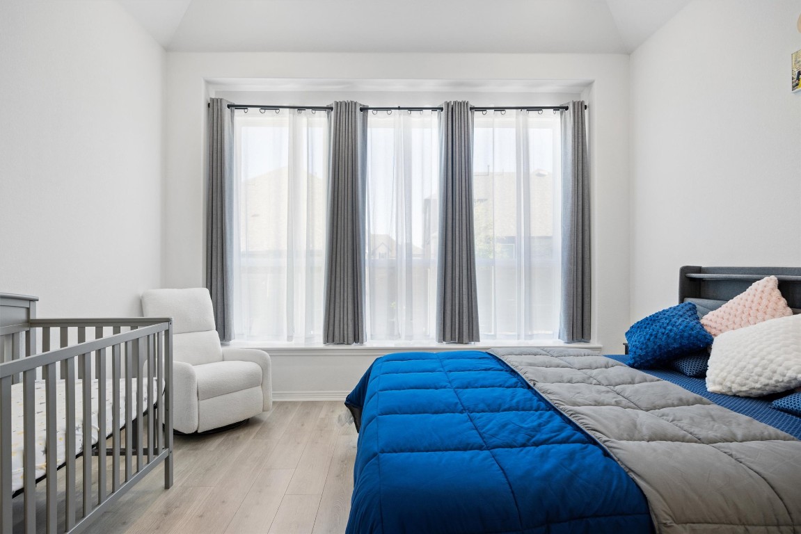 1132 Spring Gulch Lane Georgetown, TX 78628 - Photo 16 of 36 a bedroom with furniture and a large window