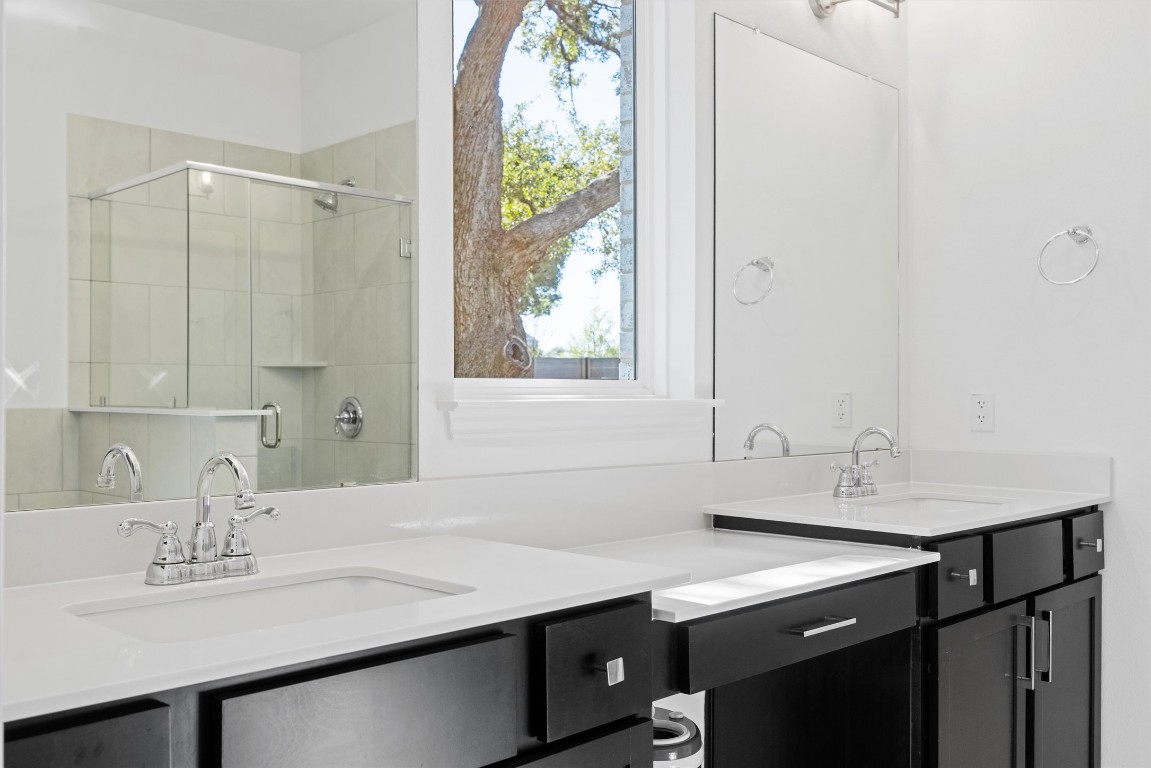 1132 Spring Gulch Lane Georgetown, TX 78628 - Photo 17 of 36 a bathroom with a sink and a mirror