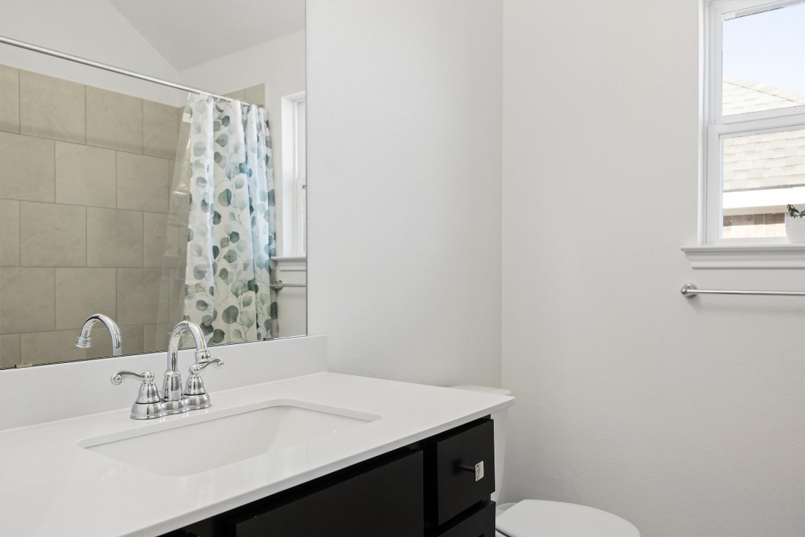 1132 Spring Gulch Lane Georgetown, TX 78628 - Photo 24 of 36 a bathroom with a sink a toilet and window