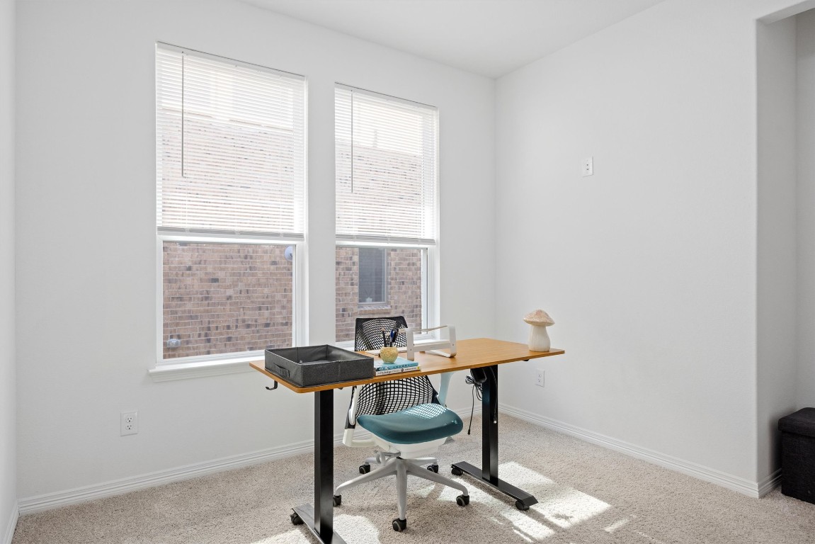 1132 Spring Gulch Lane Georgetown, TX 78628 - Photo 3 of 36 a workspace with furniture and a window