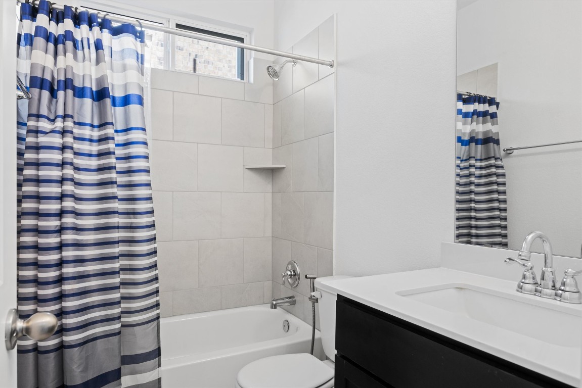 1132 Spring Gulch Lane Georgetown, TX 78628 - Photo 4 of 36 a bathroom with a sink toilet vanity and shower