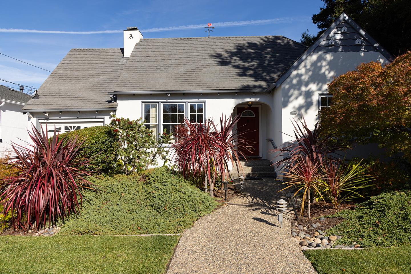 a front view of a house with garden