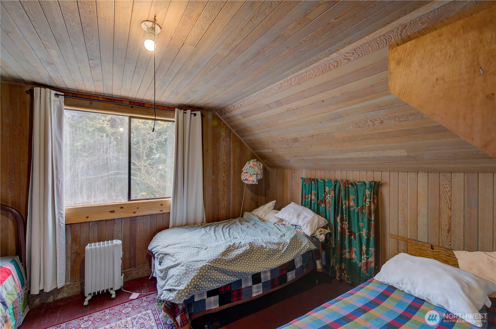 209 3rd Street Southeast Long Beach, WA 98631 - Photo 20 of 28 a bedroom with a bed and a large window