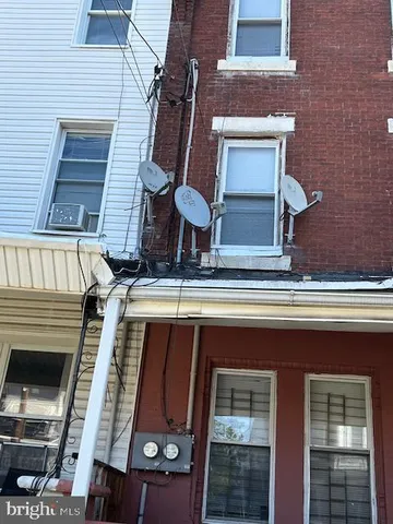 a view of a room with wooden floor and windows