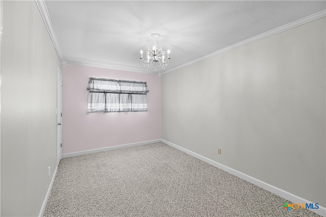 20 Hambleton Road Victoria, TX 77905 - Photo 22 of 48 an empty room with windows and chandelier fan