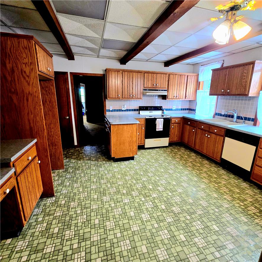 10 Barto Road Barto, PA 19504 - Photo 15 of 17 Sturdy wood cabinetry and exposed ceiling beams anchor this functional kitchen layout.