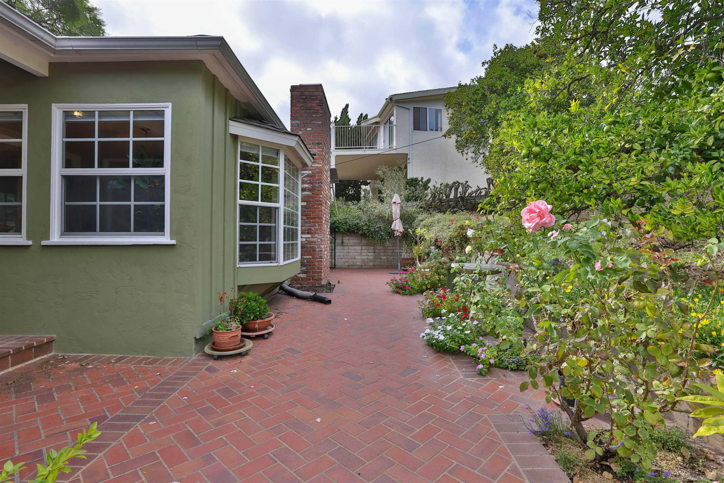 3939 Rogers Road Spring Valley, CA 91977 - Photo 17 of 48 a front view of a house with a yard and potted plants
