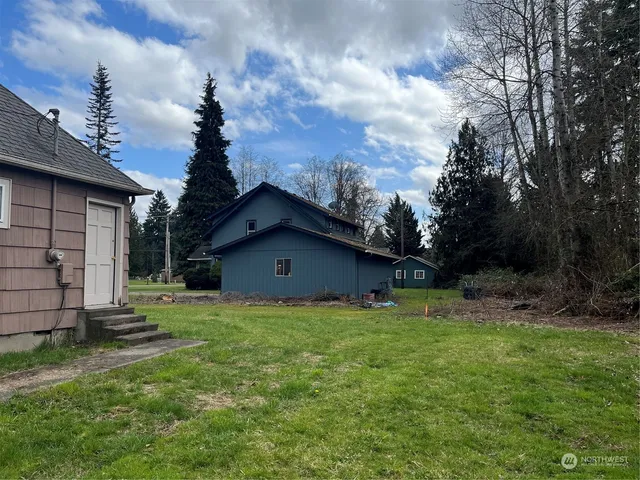 a house with huge green field in front of it