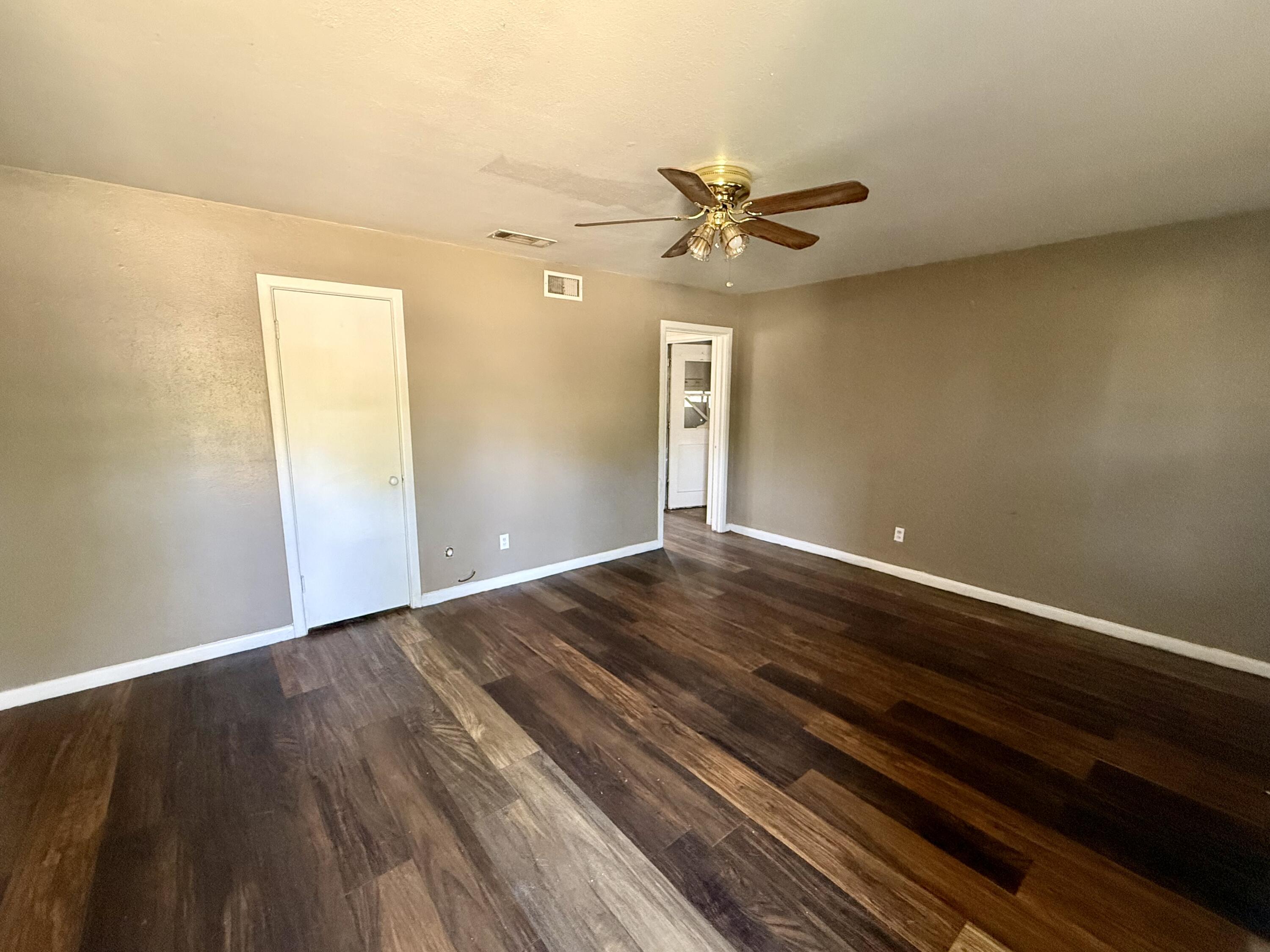2817 63rd Street Lubbock, TX 79413 - Photo 3 of 16 a view of a room with wooden floor and a ceiling fan