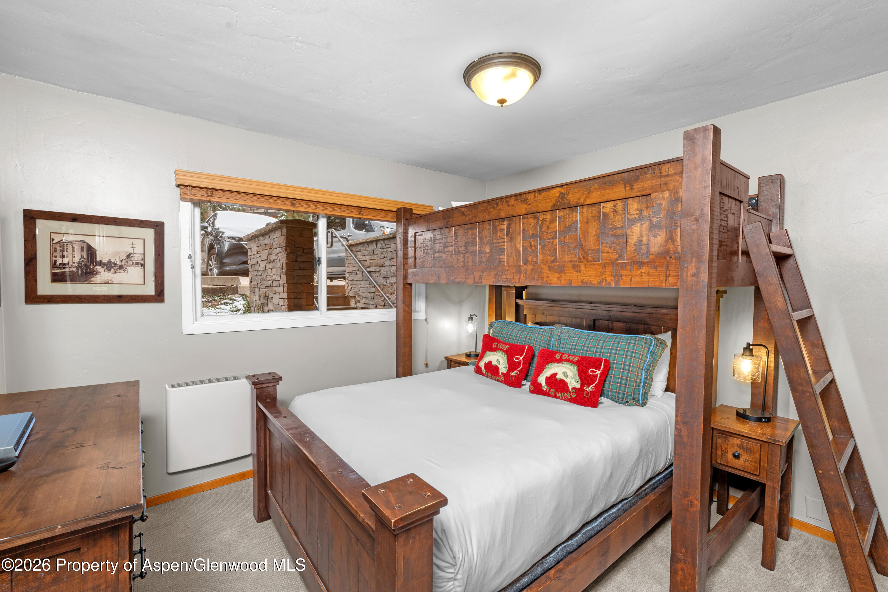 400 Wood Road, Unit 2111H Snowmass Village, CO 81615 - Photo 10 of 16 a bedroom with a bed and a table