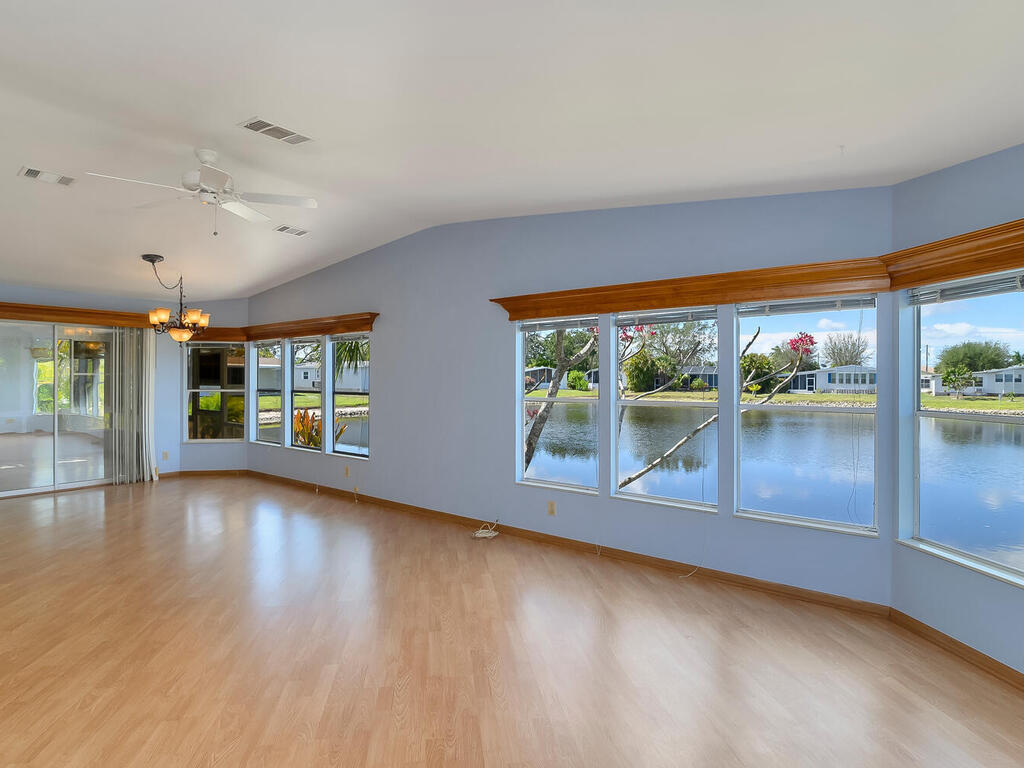 269 Riverwood Road Naples, FL 34114 - Photo 11 of 32 an empty room with wooden floor and windows