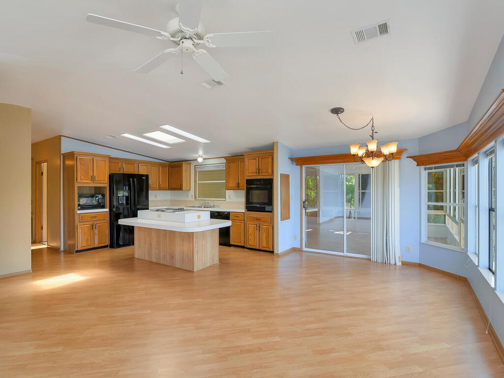 269 Riverwood Road Naples, FL 34114 - Photo 13 of 32 a large kitchen with granite countertop a stove and a sink