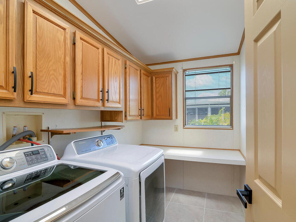 269 Riverwood Road Naples, FL 34114 - Photo 23 of 32 a utility room with dryer and washer