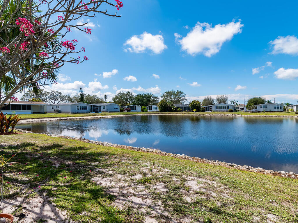 269 Riverwood Road Naples, FL 34114 - Photo 3 of 32 a view of a lake with houses in the back