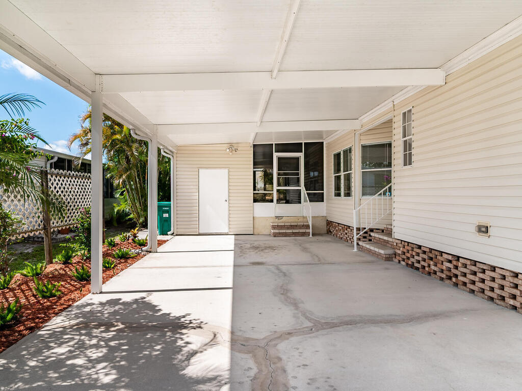 269 Riverwood Road Naples, FL 34114 - Photo 5 of 32 a hallway with wooden door and outdoor space