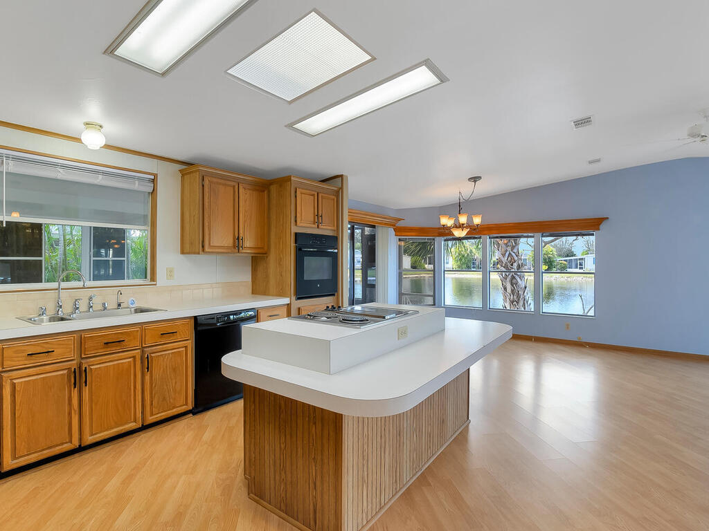 269 Riverwood Road Naples, FL 34114 - Photo 7 of 32 a kitchen with a stove a sink and a refrigerator