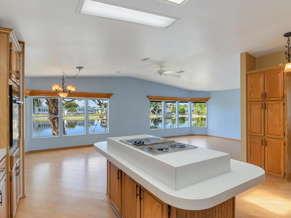 269 Riverwood Road Naples, FL 34114 - Photo 9 of 32 a white kitchen with a stove a sink and a refrigerator