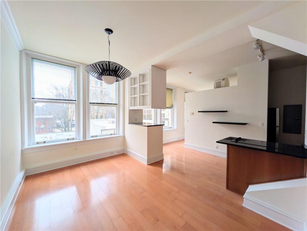 a kitchen with stainless steel appliances granite countertop a refrigerator a stove and a wooden floors