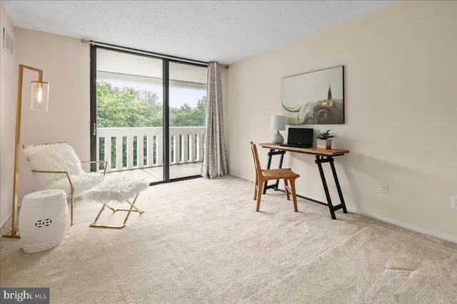 a view of a room with a table and chairs
