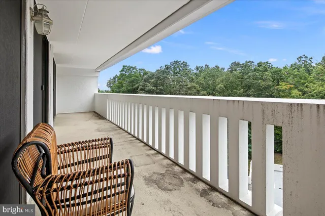 a living room with furniture and a lamp