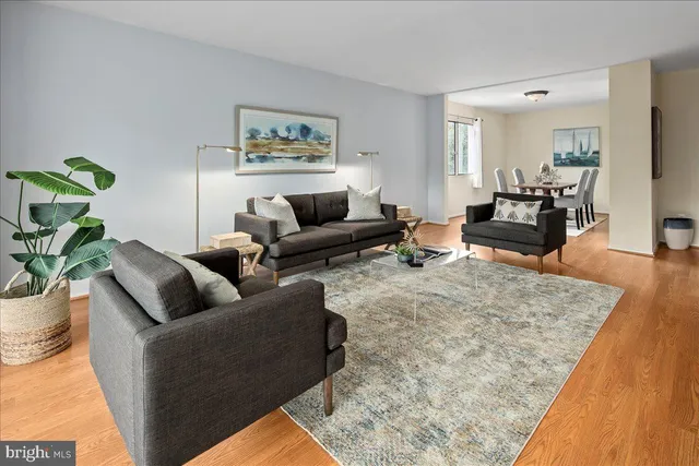 a living room with furniture or couch and a wooden floor