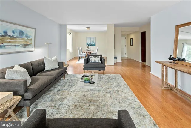 a living room with furniture and a wooden floor