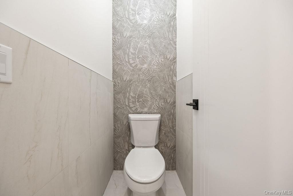 62 Blauvelt Road, Unit 202 Monsey, NY 10952 - Photo 13 of 34 a white toilet sitting in a bathroom