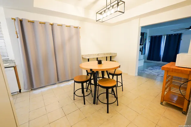 a dining room with furniture and a rug