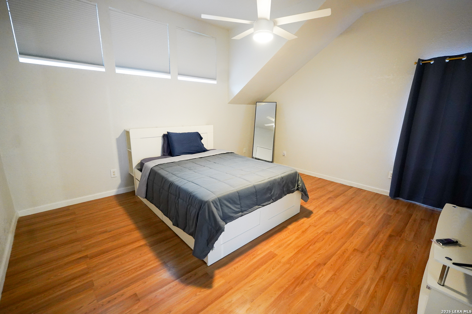 1823 Copperfield Road San Antonio, TX 78251 - Photo 15 of 25 a bedroom with a bed and wooden floor