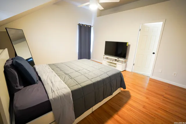 a bedroom with a bed and a flat screen tv
