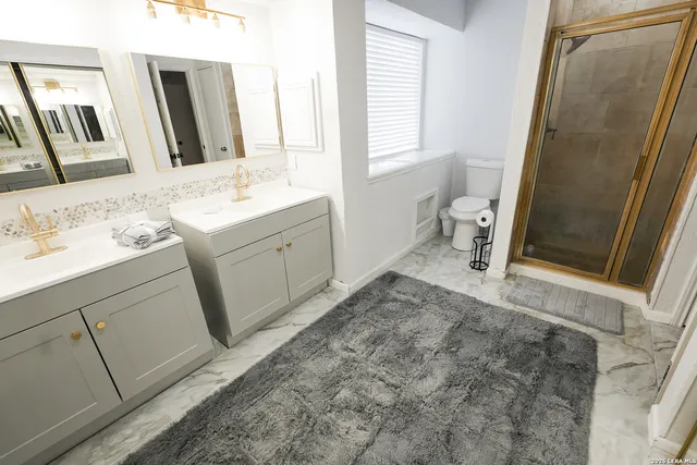 a bathroom with a sink a toilet and a mirror