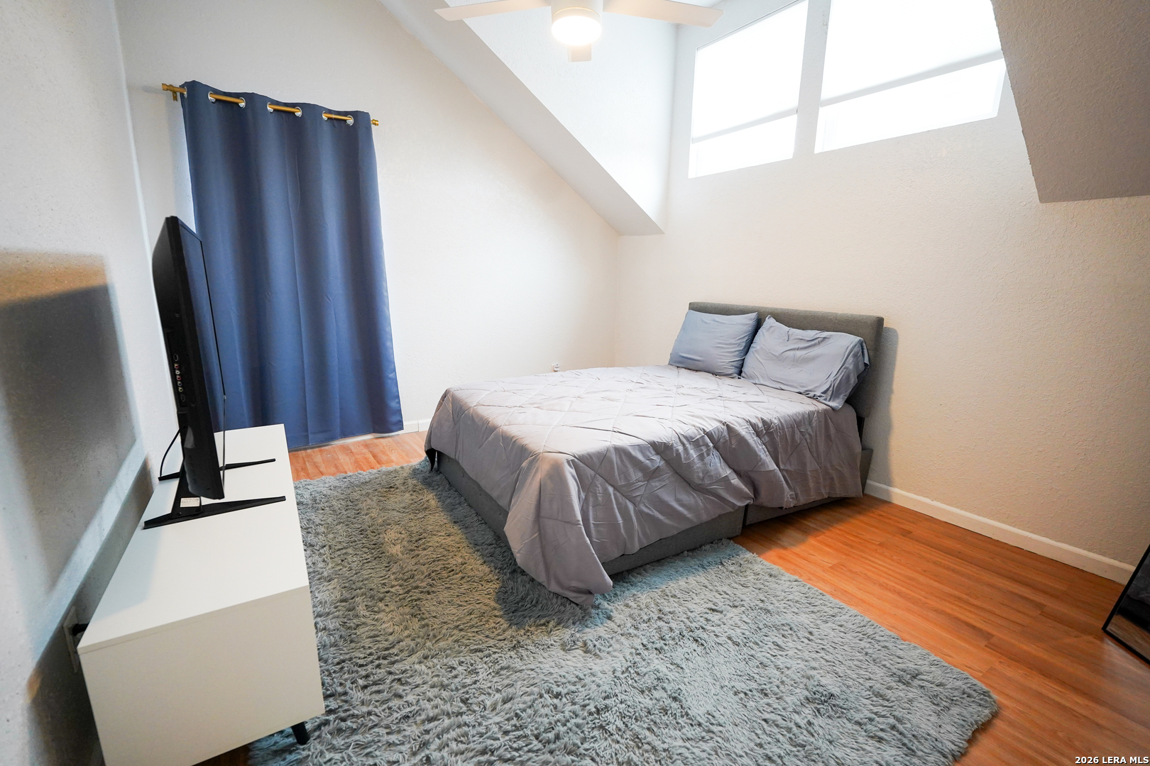 1823 Copperfield Road San Antonio, TX 78251 - Photo 23 of 25 a bedroom with a bed and wooden floor