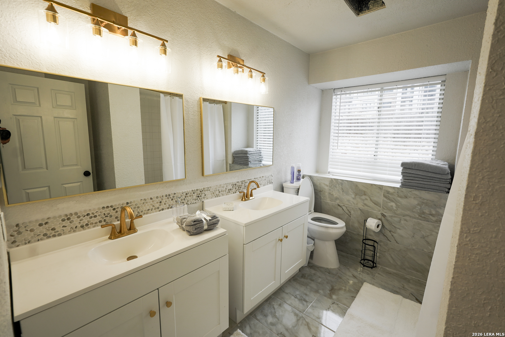 1823 Copperfield Road San Antonio, TX 78251 - Photo 24 of 25 a bathroom with a double vanity sink mirror and toilet