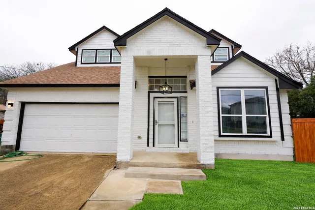 a front view of a house with a yard and garage