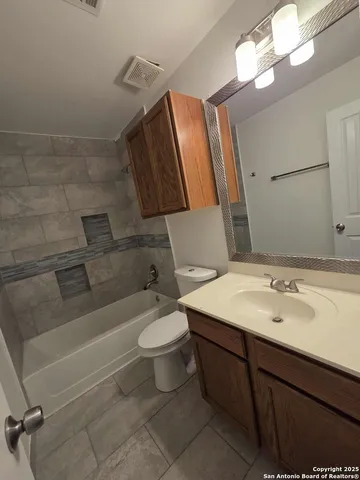 a bathroom with a sink a toilet and bathtub