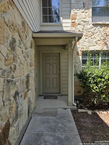 a front view of a house with plants