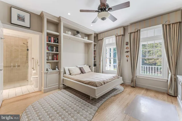 a living room with furniture kitchen view and a chandelier
