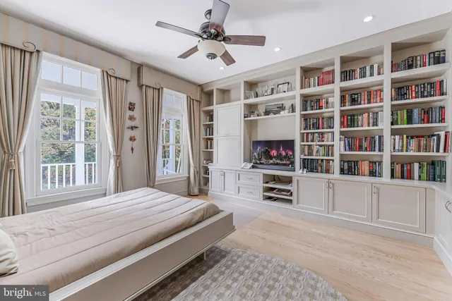 a dining room with furniture a chandelier and wooden floor
