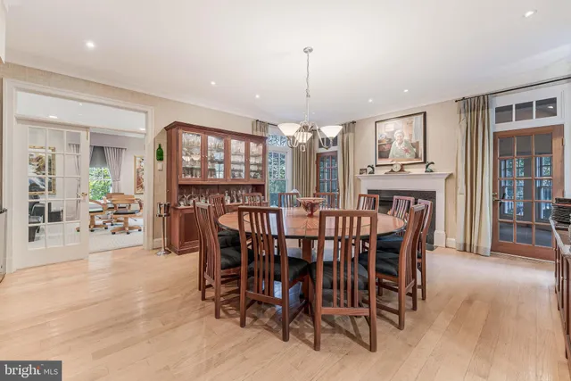 a bathroom with a toilet a sink a glass door a shower and a mirror