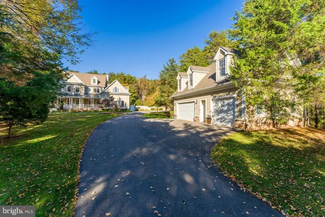 a view of a house with a yard and potted plants