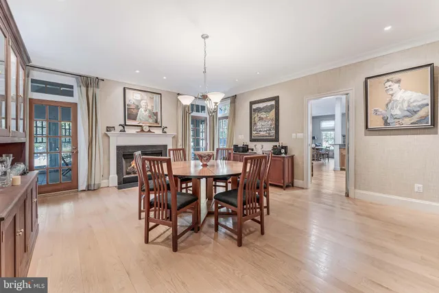 a view of a kitchen with refrigerator and white cabinets
