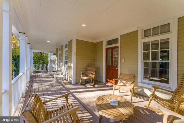 a living room with furniture a flat screen tv and a book shelf