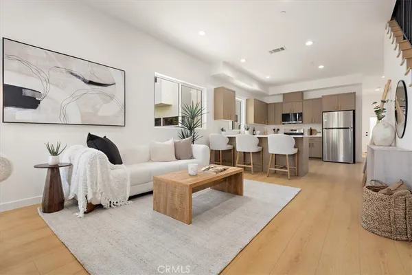 a living room with lots of furniture and white walls